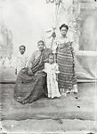 Family with two children, parents in Ewe kente cloth with painted backdrop