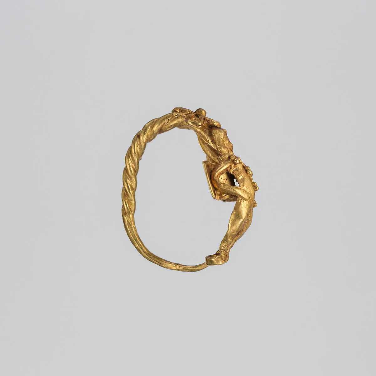 Gold earring with winged figure (one of a pair) — Unknown