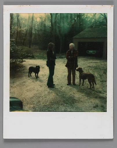 [Mary Knollenberg, Dogs, and Unidentified Woman in Driveway]