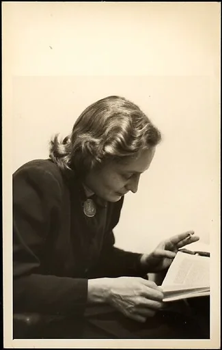 [Eleanor Clark, Reading and Holding Cigarette]