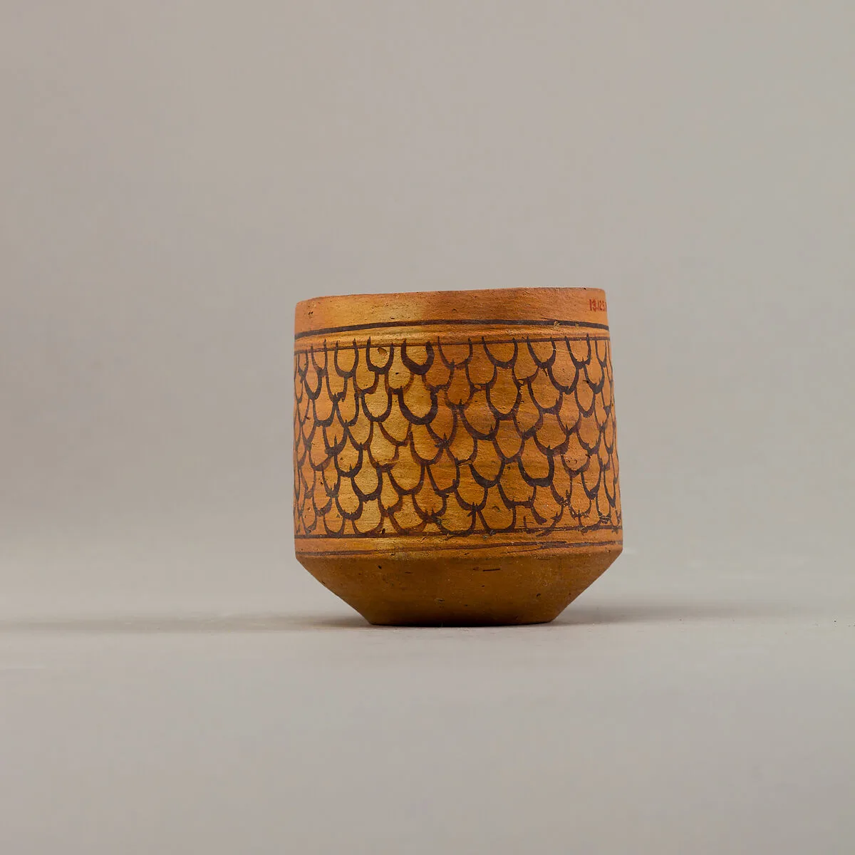 Cup with feather (?) decoration — Unknown