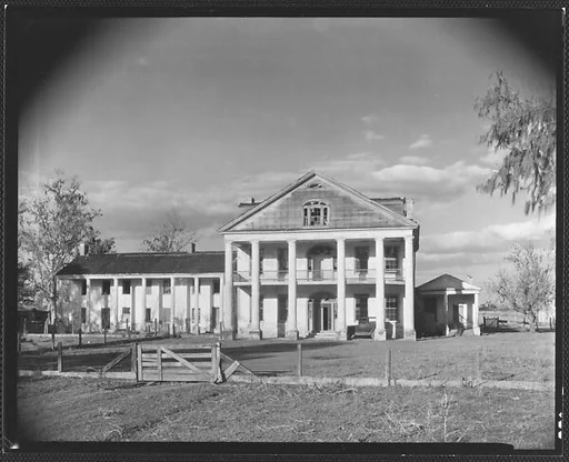 [Dilapidated Plantation House with Broken Windows in Gable]