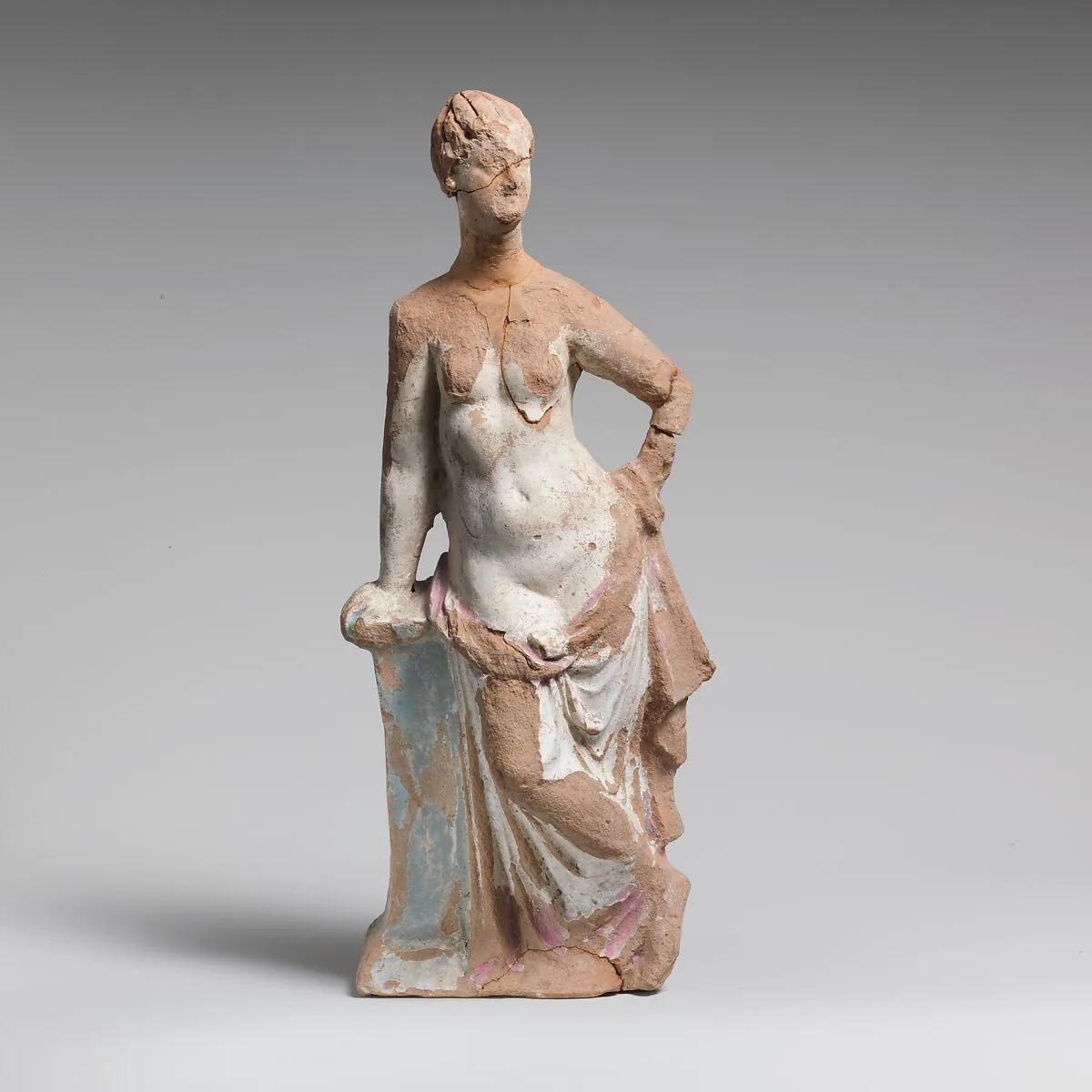 Terracotta statuette of a woman leaning on a pillar — Unknown
