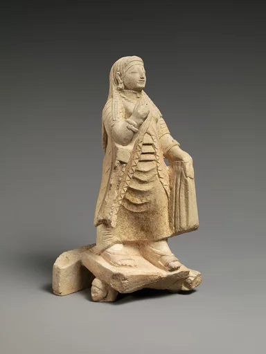 Limestone figure of a woman