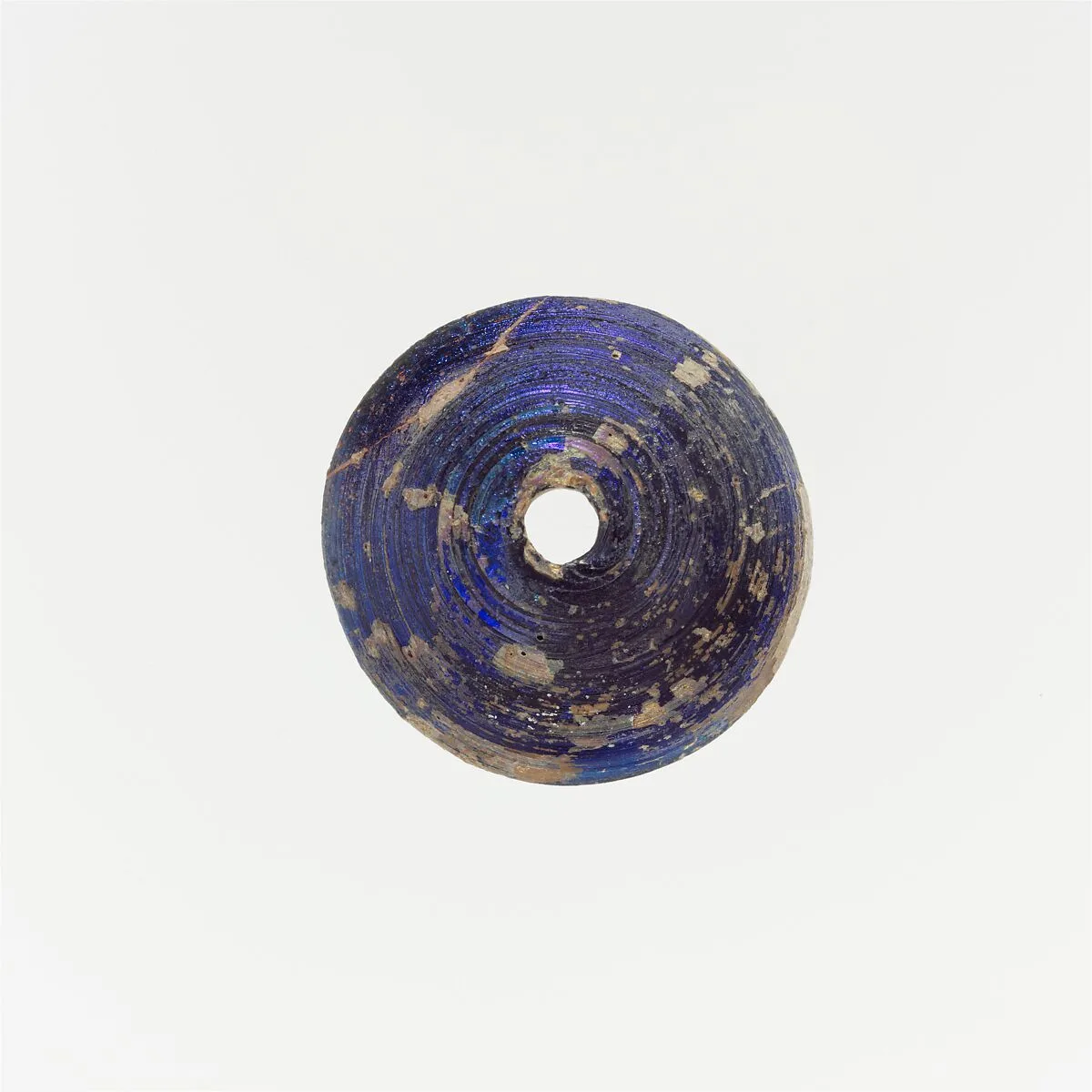 Glass spindle whorl — Unknown