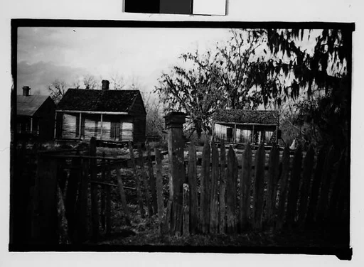 [Wooden Houses Behind Fence, New Orleans Vicinity, Louisiana]