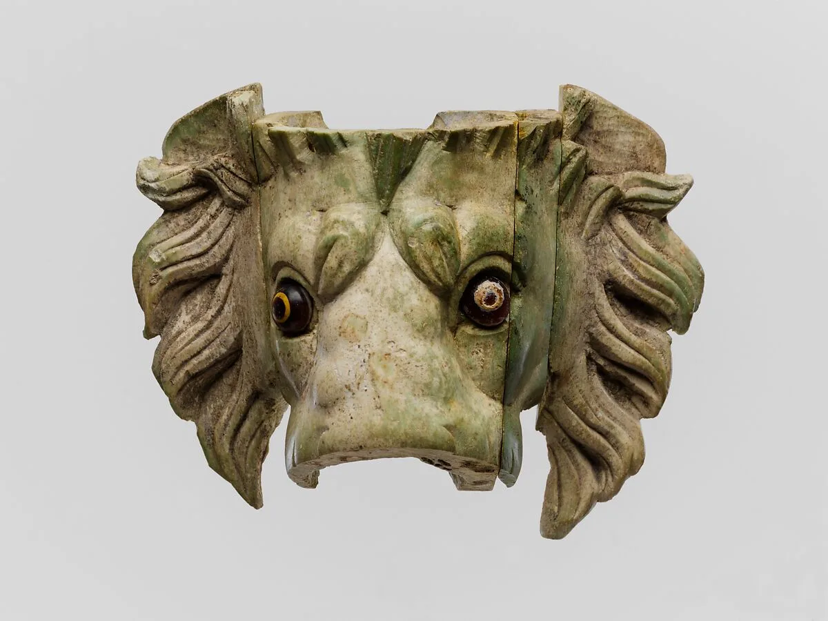 Bone lion's head protome with glass eyes — Unknown