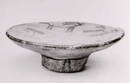 Footed plate with horned animals