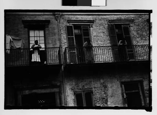 [People on Balconies of Shuttered Houses in French Quarter, New Orleans, Louisiana]