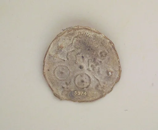 Lead votive roundel with table offerings
