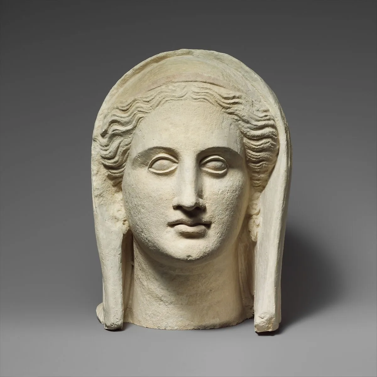 Limestone head of a veiled female votary — Unknown