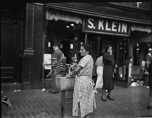 [Woman Selling Pretzels Outside S. Klein-on-the-Square Department Store, Union Square East, New York City]