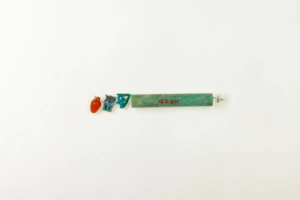 String of 3 amulets and 1 cylindrical bead — Unknown