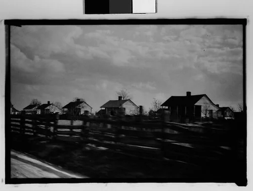 [Wooden Houses by Road Behind Slat Fence, From Moving Automobile, New Orleans Vicinity, Louisiana]