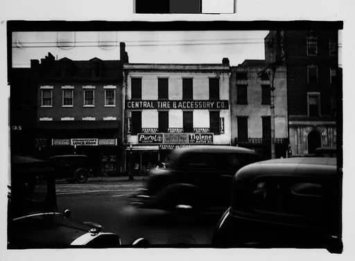 [Main Street Buildings with Passing and Parked Cars in Foreground, Augusta, Georgia]