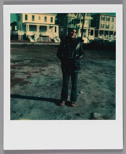 [Woman with Camera in Vacant Lot]