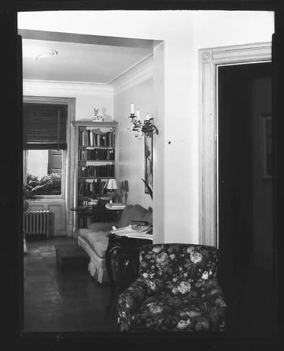 [View Through Doorway into Living Room with Armchair in Foreground]