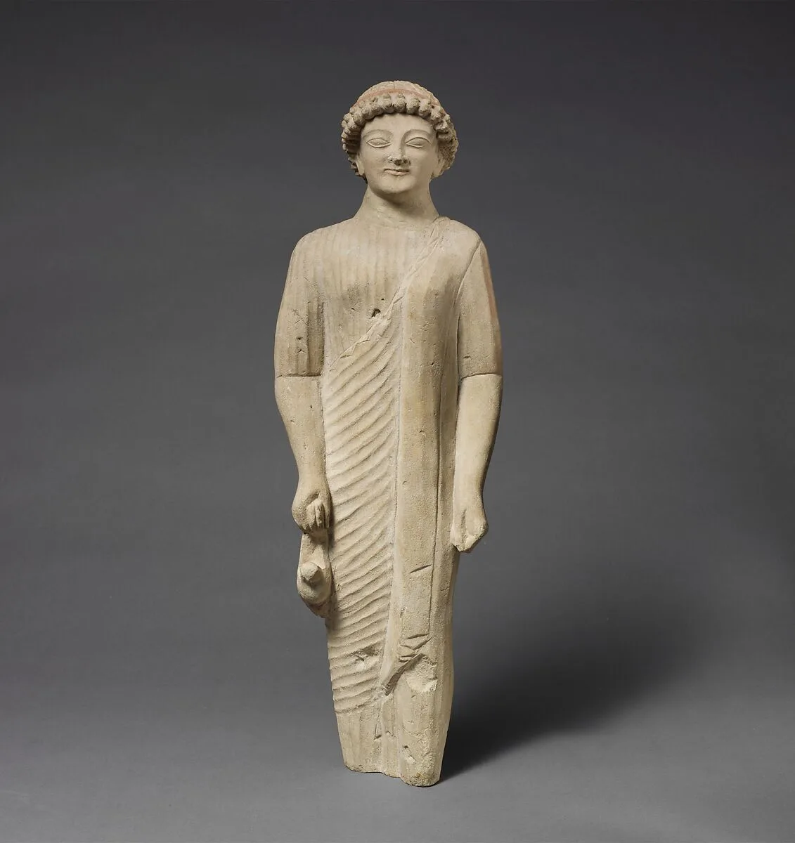 Limestone statuette of a beardless male votary with a fillet — Unknown