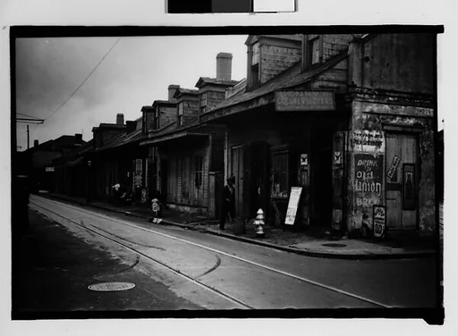 [Row of Shuttered Houses with Corner Laundry in French Quarter, New Orleans, Louisiana]