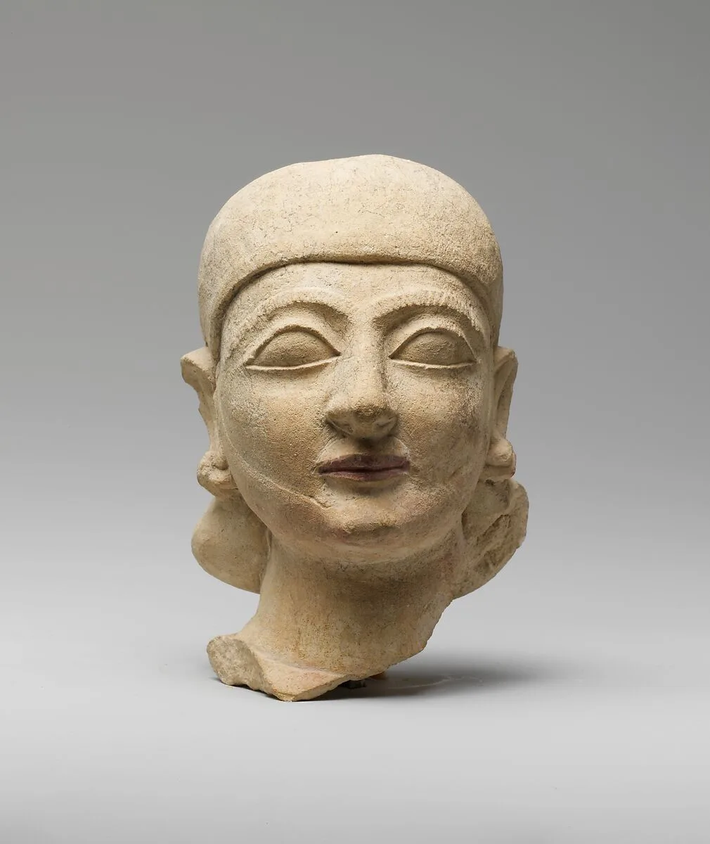 Limestone head of a man with a plain headdress — Unknown