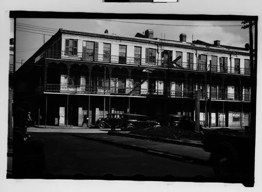 [Cast-Iron Balconied Houses with Parked Cars and Pedestrian on Street Corner, Mobile, Alabama]