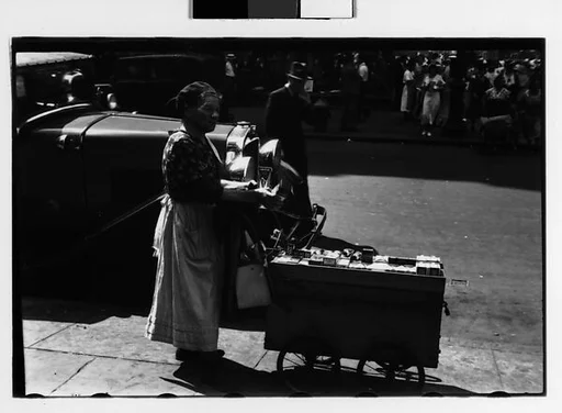 [Two 35mm Film Frames: Housegoods Vendor and Cart in Front of Parked Car, Fourteenth Street, and Woman and Children on Street, New York City]