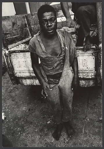[Shoeless Man Standing Behind Pick-up Ttruck, Haiti]
