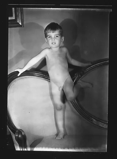 [Unidentified Naked Child Standing on Couch]
