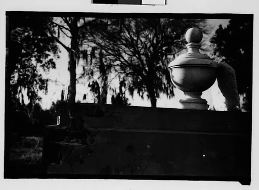 [Gravestone and Marker on Ledge in Cemetery Yard, Louisiana]