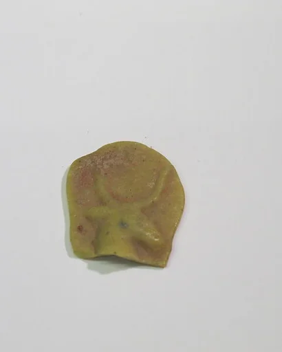Mold-pressed amulet or fragment