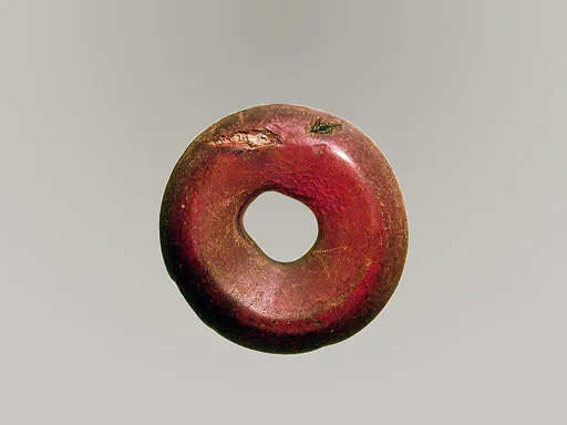 Pierced disk, perhaps from an earring or fibula (safety pin)