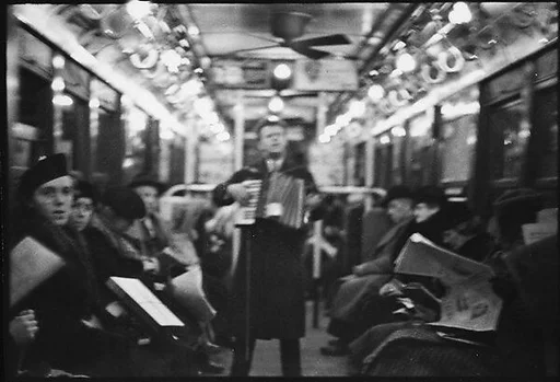 [Three 35mm Film Frames: View Down Subway Car with Accordionist Performing in Aisle, New York City]