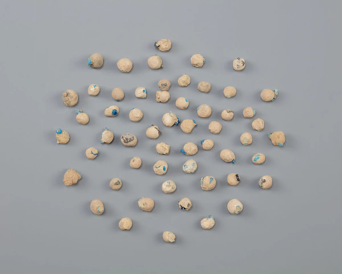 Tray of clay balls with embedded faience ring beads — Unknown