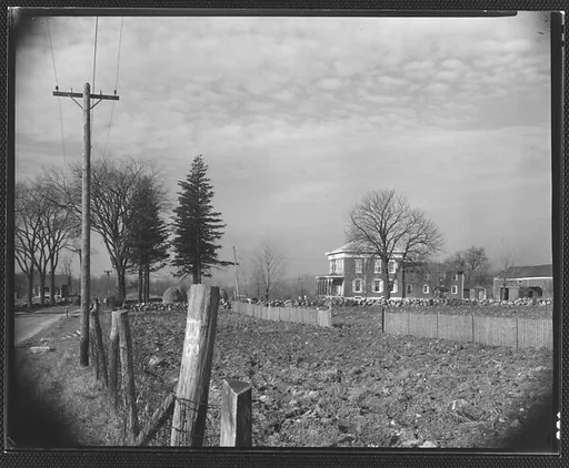 [Greek Revival House From Road with Fenceposts in Foreground, Brewster, New York]