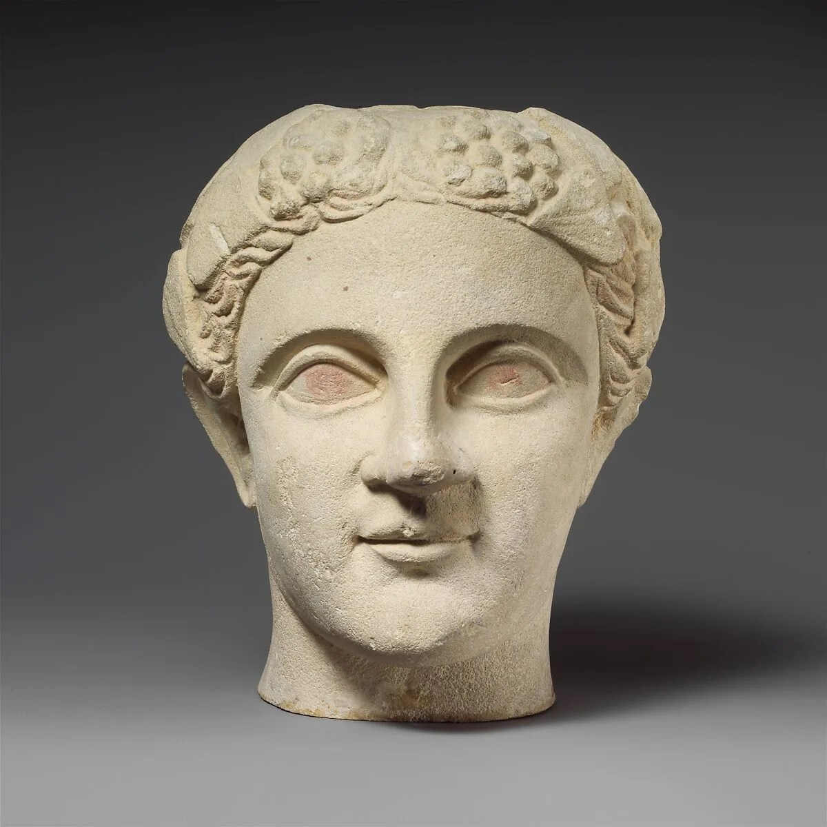 Limestone head of a wreathed youth — Unknown