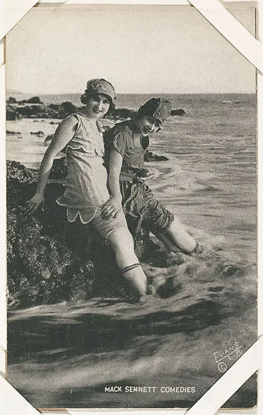 Actresses Lillian Langston and Claire Anderson on rock with feet in water from Mack Sennett Comedies Arcade series (W423) — Unknown