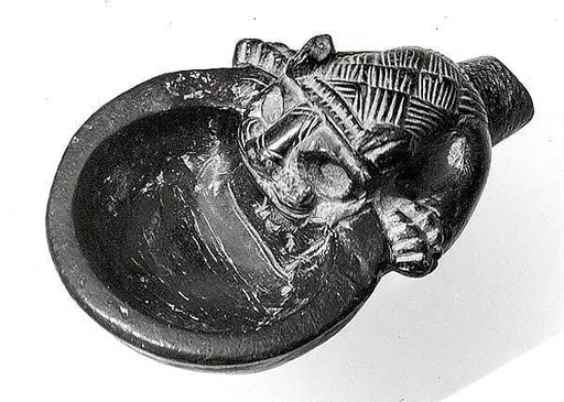 Bowl with a handle in the form of the forepart of a lion