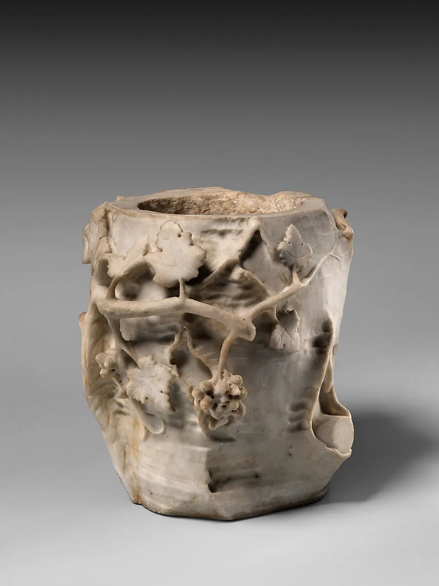 Marble cinerary urn in the form of a tree stump with leaves and grapes — Unknown
