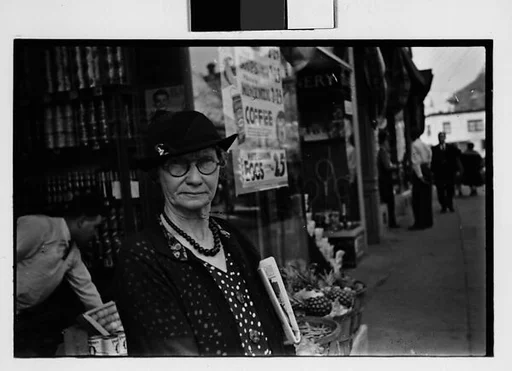 [Two 35mm Film Frames: Old Woman Outside Main Street Grocery Store, Main Street Sidewalk, Ossining, New York]
