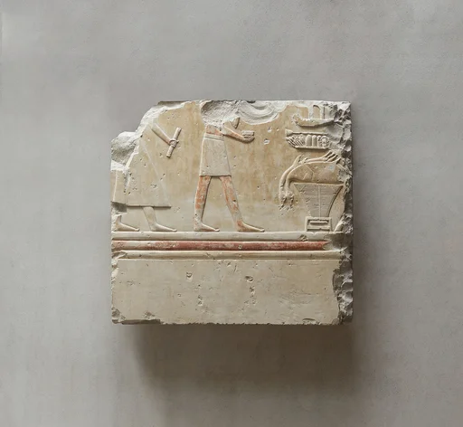 Relief from the tomb of Queen Neferu: a scribe and a cupbearer approach the queen's offering table