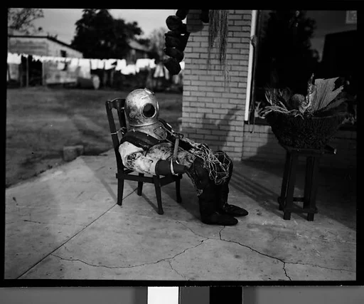 [Sponge Diver's Suit in Front of Mermaid Curio Shoppe, Florida]