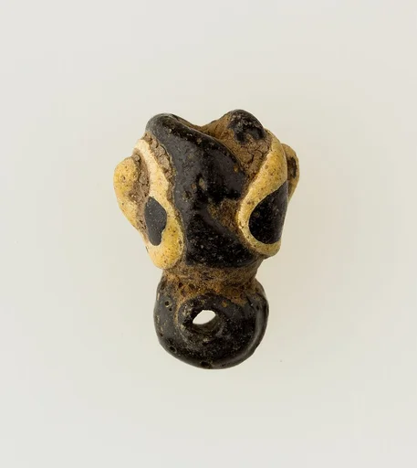 Amulet in form of human face