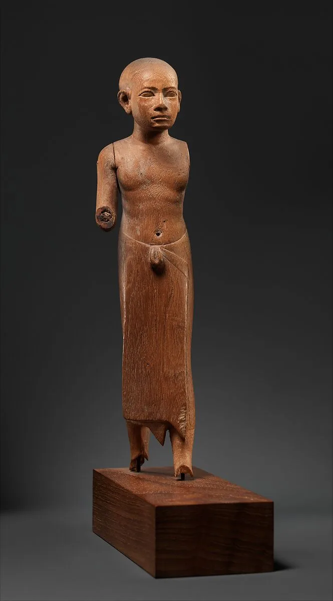 Figure of a Striding Man with a Long Kilt — Unknown