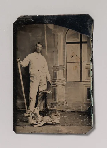 [Painter, Standing in Front of a Painted Window Backdrop, with Brushes, Bucket, and Paint Cans]