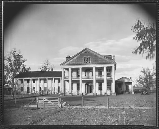 [Dilapidated Plantation House with Broken Windows in Gable]