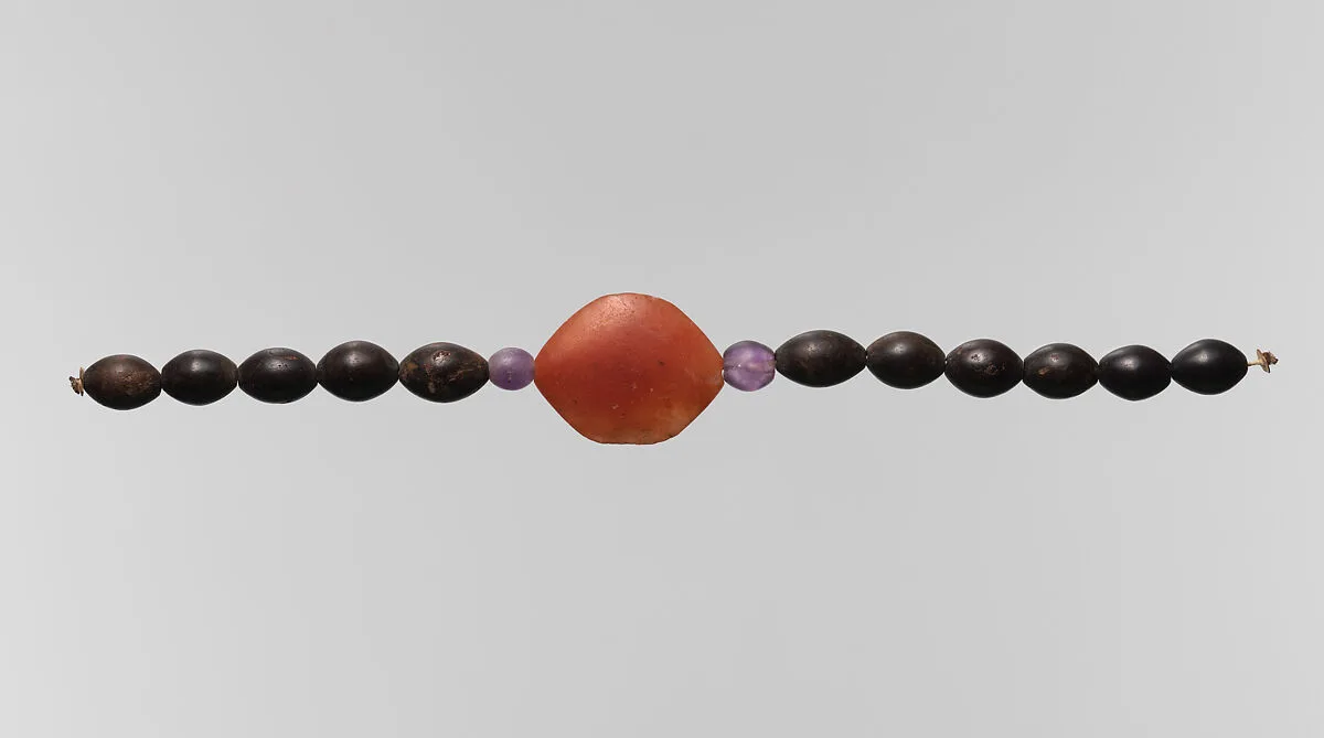 String of beads, barrel and one acacia — Unknown