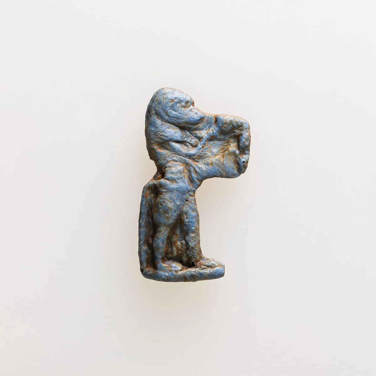 Amulet of a baboon holding an unrecognizable object — Unknown