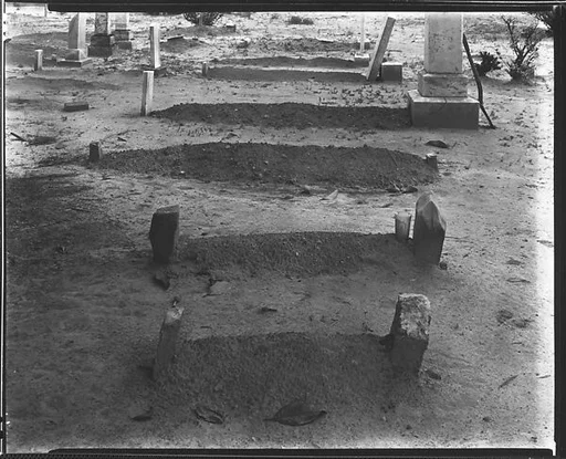 [Graveyard with Stone, Marble, and Wood Headstones]