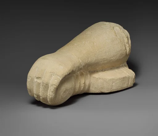 Limestone arm holding a sword