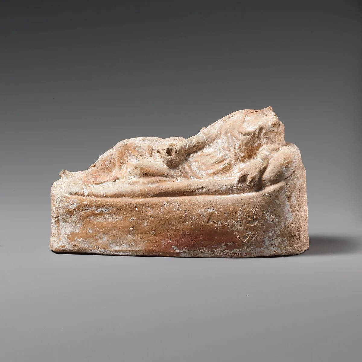 Terracotta statuette of a woman reclining on a couch — Unknown